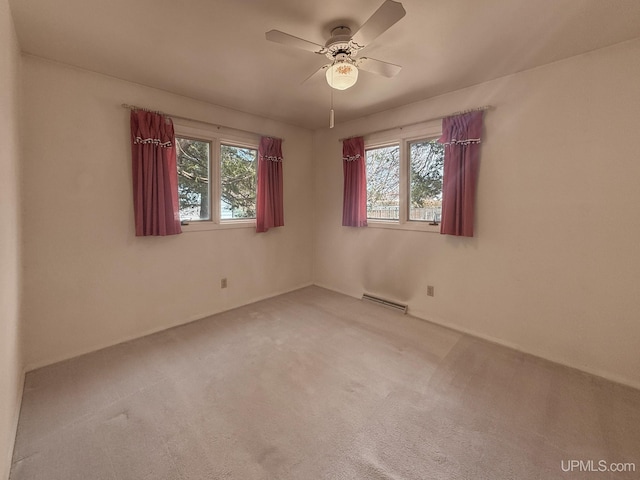 empty room with a healthy amount of sunlight, ceiling fan, light carpet, and visible vents