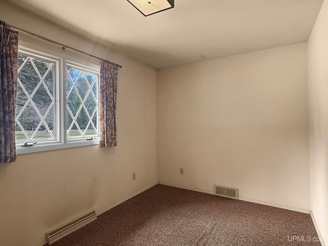 carpeted empty room with baseboards, a baseboard heating unit, and visible vents