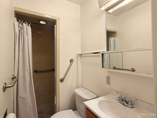 bathroom featuring vanity, a tile shower, and toilet