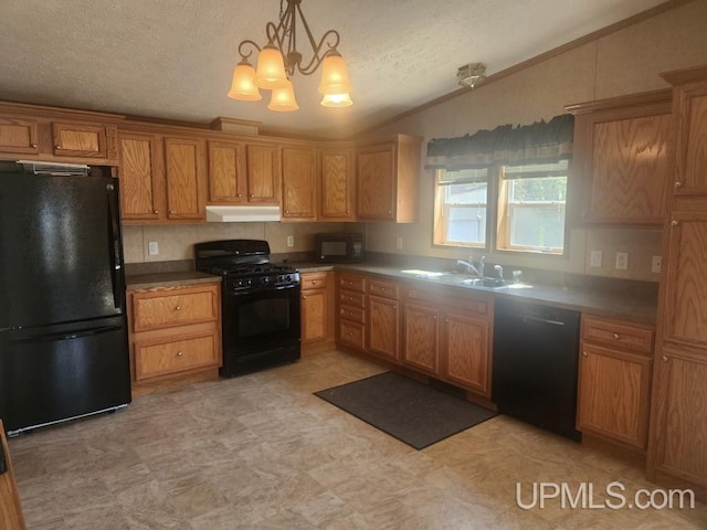 kitchen featuring a textured ceiling, a sink, black appliances, lofted ceiling, and under cabinet range hood
