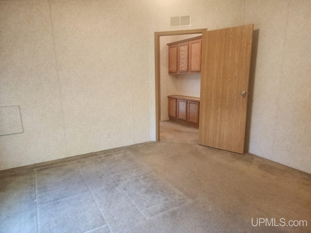 empty room with light carpet and visible vents