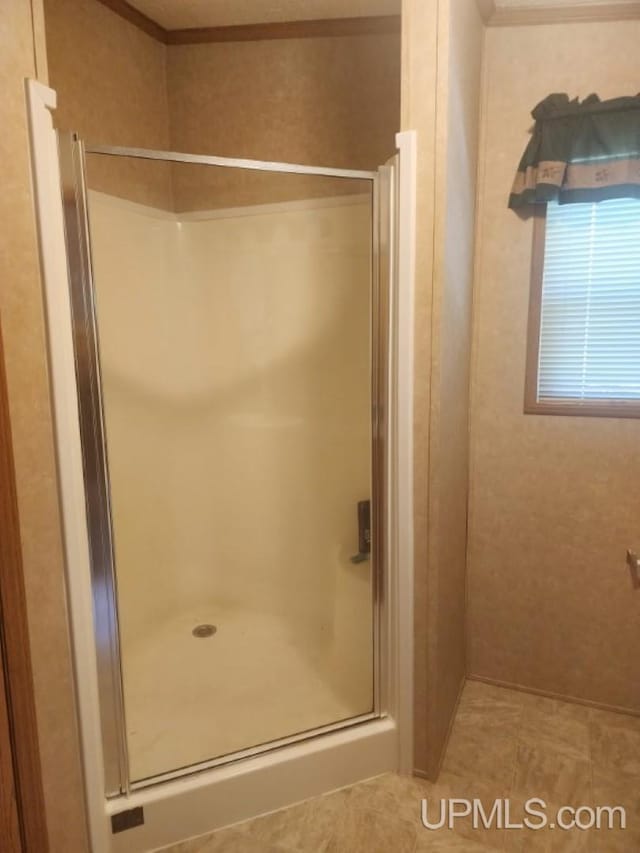 full bathroom featuring tile patterned flooring and a stall shower