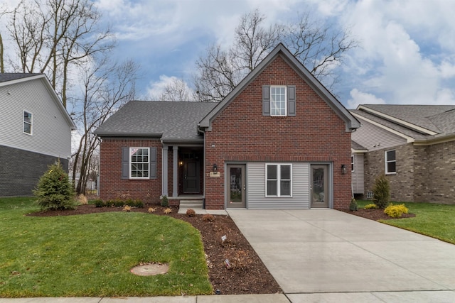 traditional-style house with brick siding, a front lawn, roof with shingles, and driveway