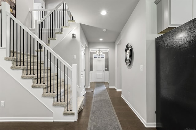 foyer featuring recessed lighting, baseboards, stairs, and dark wood-type flooring