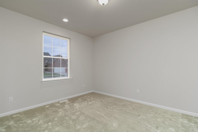 carpeted empty room with recessed lighting and baseboards