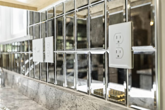 exterior details featuring white cabinetry and glass insert cabinets