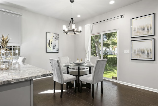 dining area featuring dark wood-type flooring, recessed lighting, baseboards, and a notable chandelier