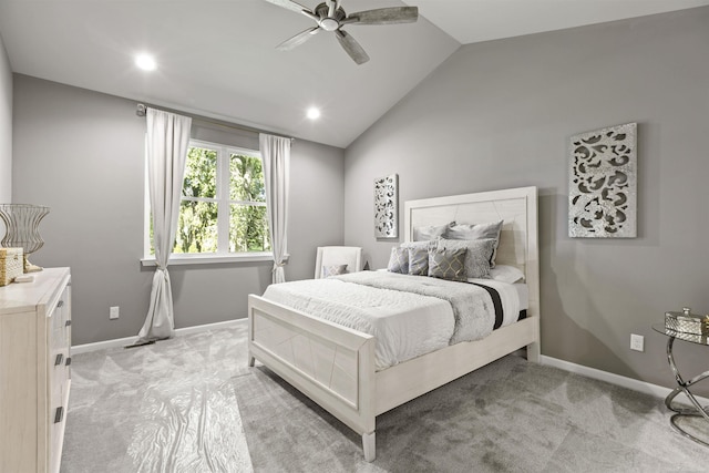 bedroom featuring light colored carpet, a ceiling fan, baseboards, and lofted ceiling