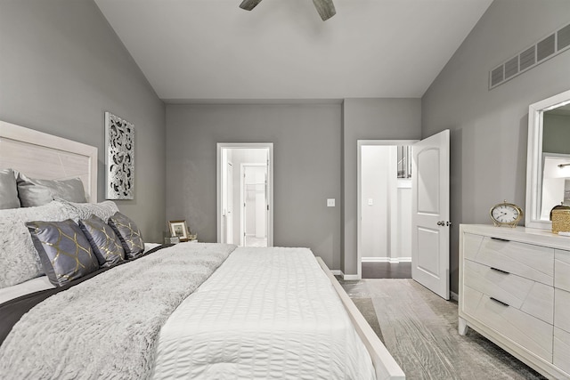bedroom with connected bathroom, ceiling fan, visible vents, and lofted ceiling