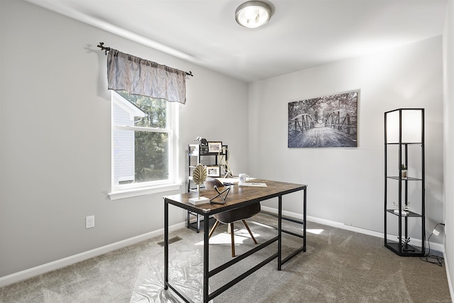 carpeted office space with baseboards and visible vents