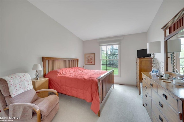 bedroom with light carpet and lofted ceiling