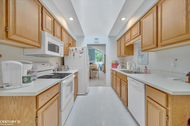 kitchen featuring a sink, light countertops, white appliances, and light floors