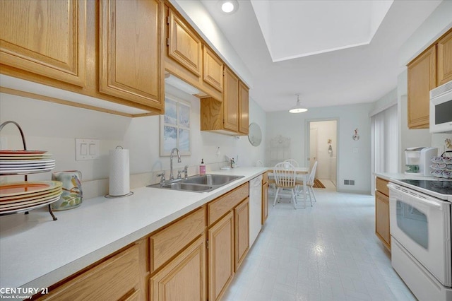 kitchen featuring a sink, light countertops, white appliances, and visible vents