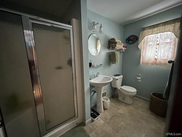 full bath with toilet and a stall shower