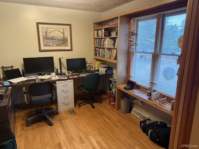 office area featuring a textured ceiling and light wood-style floors