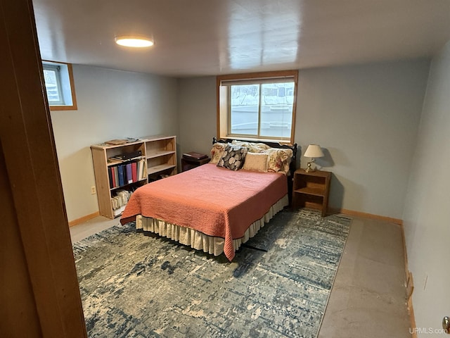 bedroom featuring baseboards and multiple windows