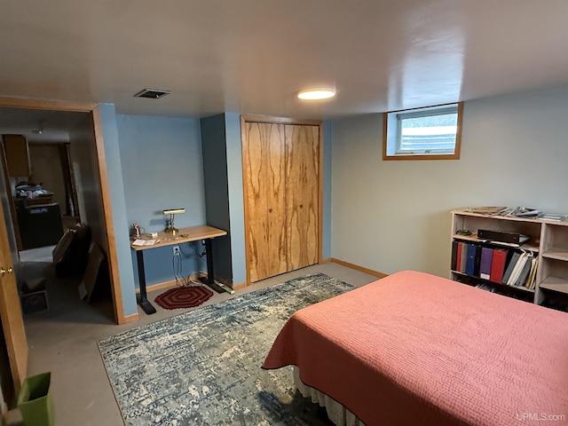 bedroom with baseboards, a closet, and visible vents