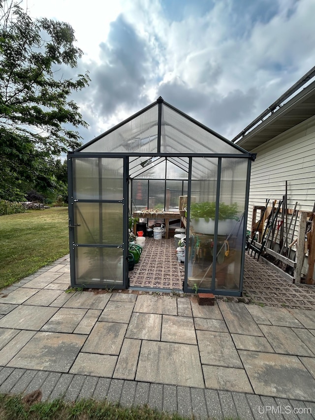 view of patio featuring an outdoor structure and an exterior structure