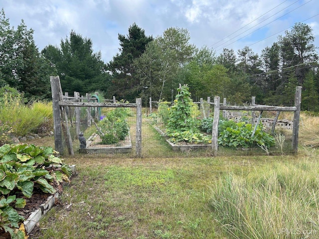 view of gate with a garden