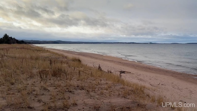 property view of water featuring a beach view