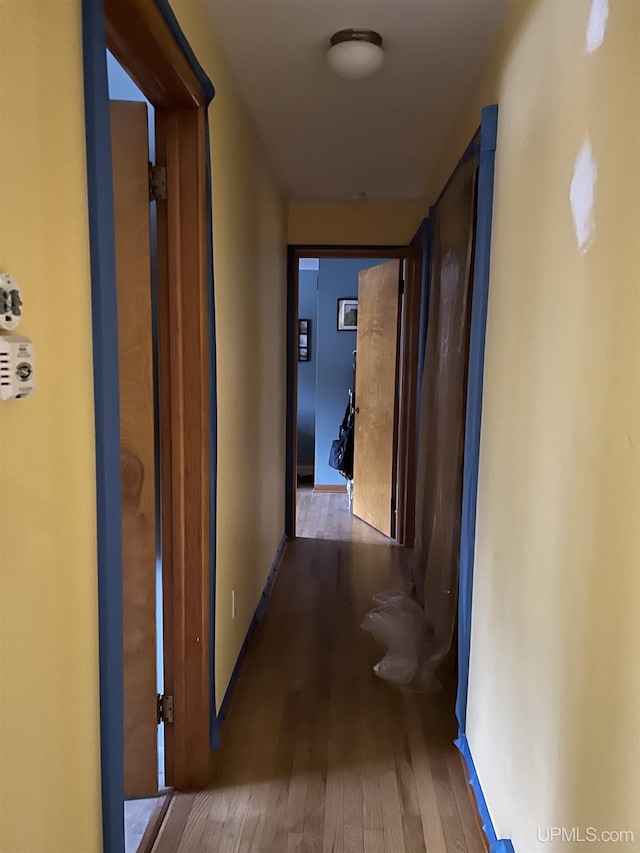 corridor featuring wood finished floors