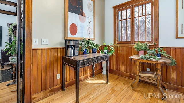 interior space featuring wooden walls, wainscoting, and hardwood / wood-style flooring