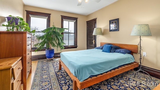bedroom featuring ceiling fan and wood finished floors