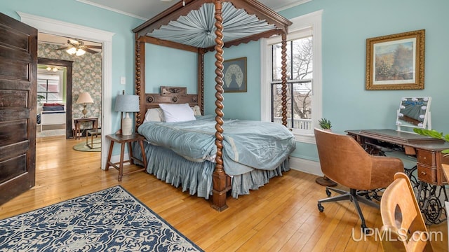 bedroom featuring crown molding, baseboards, and hardwood / wood-style flooring