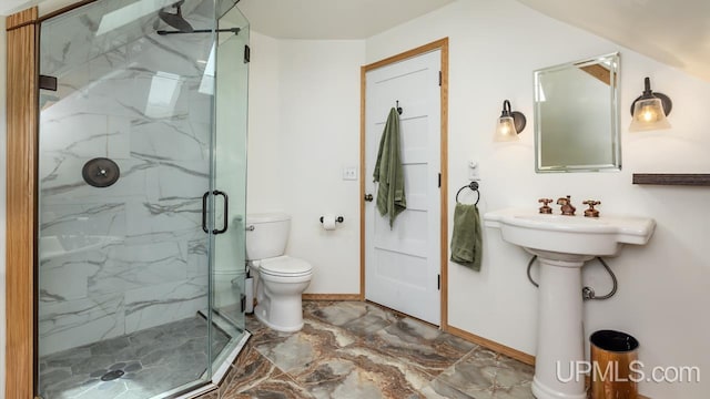 full bathroom featuring baseboards, toilet, a marble finish shower, and marble finish floor