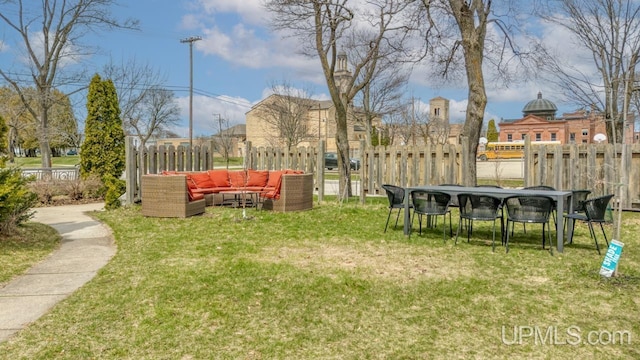 view of yard with outdoor lounge area and fence