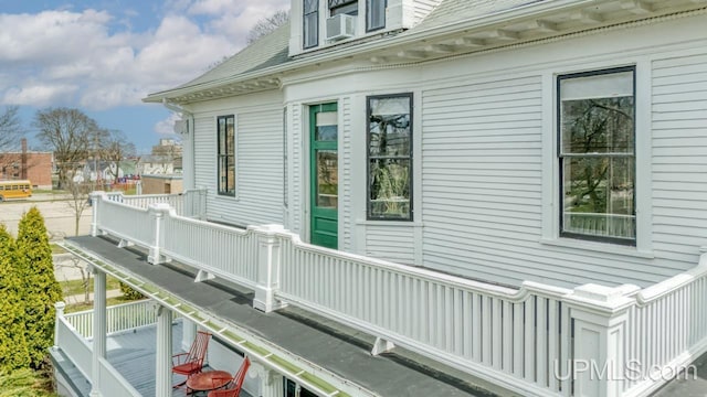 view of side of property with a balcony and cooling unit