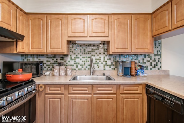 kitchen with light countertops, a sink, tasteful backsplash, and stainless steel appliances
