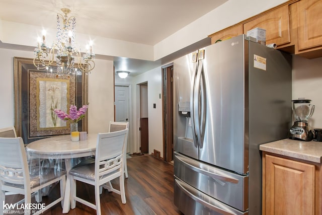 kitchen with light countertops, dark wood finished floors, a chandelier, and stainless steel fridge with ice dispenser