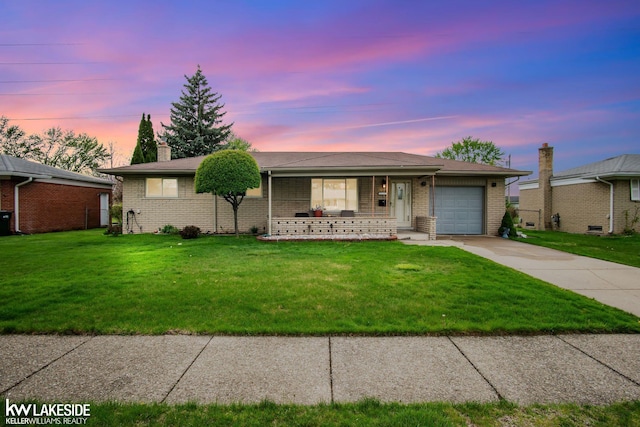 ranch-style home featuring an attached garage, driveway, brick siding, a porch, and a yard