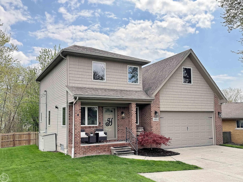 view of front of house with fence, a shingled roof, a front lawn, a porch, and concrete driveway