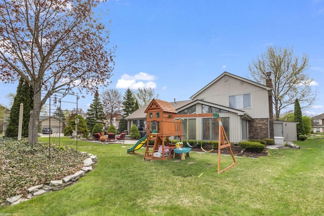 back of property featuring a playground, a chimney, and a lawn