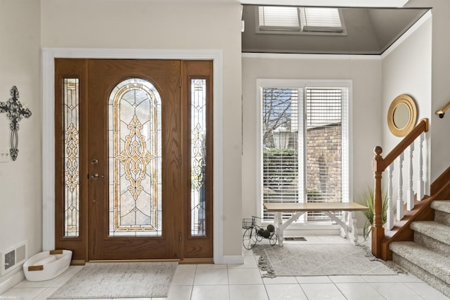 foyer with stairs, baseboards, visible vents, and tile patterned flooring