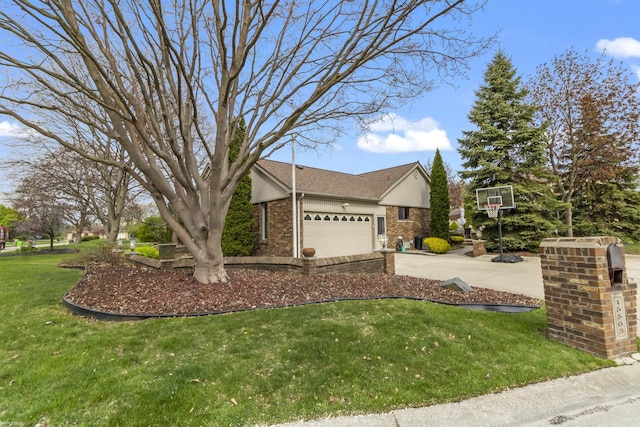 view of side of property with brick siding, a garage, a yard, and concrete driveway