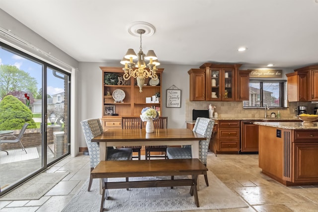 dining area with recessed lighting, a notable chandelier, and stone tile flooring