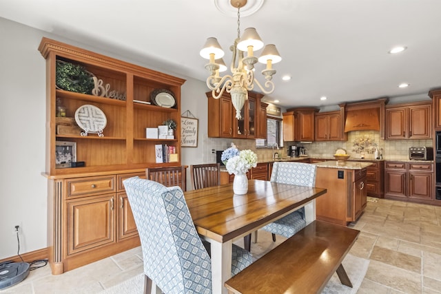 dining room with stone tile flooring, recessed lighting, and a chandelier