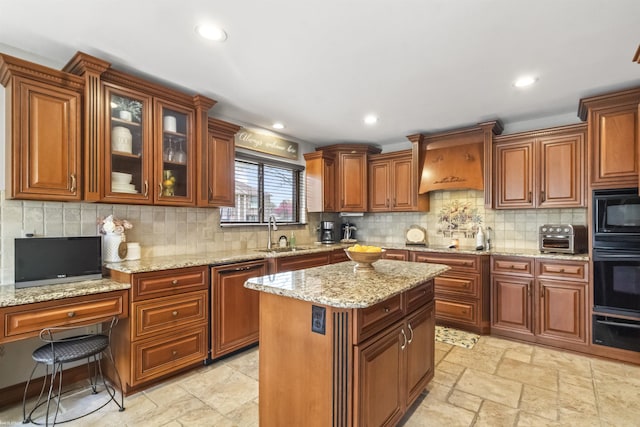 kitchen featuring brown cabinets, a sink, tasteful backsplash, glass insert cabinets, and black appliances