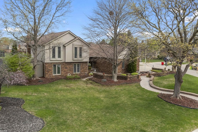 view of side of property with brick siding and a lawn
