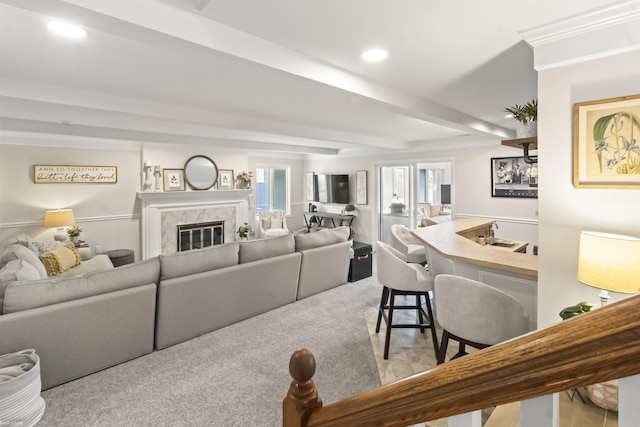 carpeted living room with recessed lighting and a high end fireplace