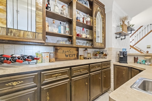 bar featuring a sink, tasteful backsplash, and a bar
