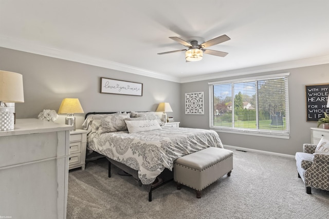 carpeted bedroom featuring baseboards, ornamental molding, and ceiling fan