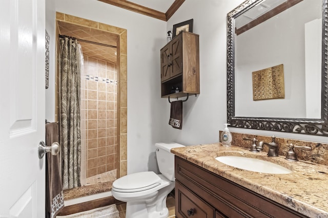 full bath featuring crown molding, toilet, a shower stall, and vanity