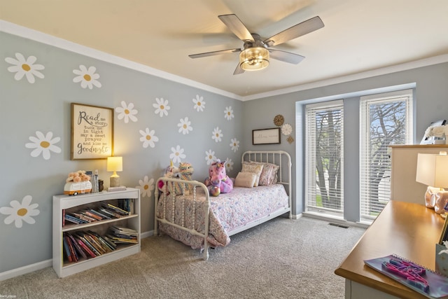 carpeted bedroom featuring crown molding, a ceiling fan, baseboards, and visible vents