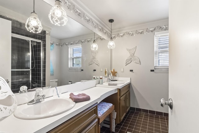 bathroom with a sink, tile patterned flooring, double vanity, toilet, and a stall shower