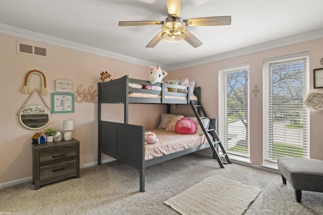 bedroom with ornamental molding, carpet, and visible vents