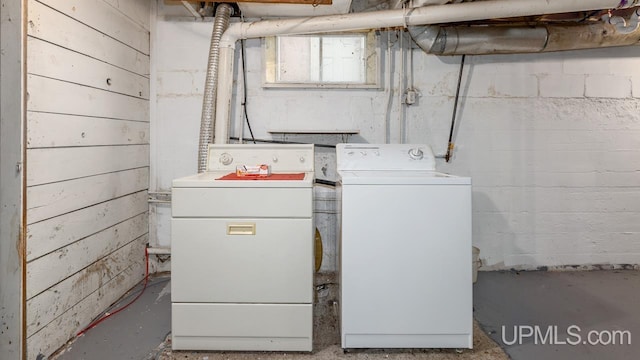 clothes washing area with separate washer and dryer and laundry area